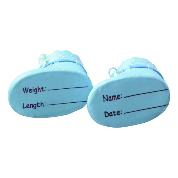 Underside of blue baby booties showing labeled areas to write baby's name, weight, length, and birth date