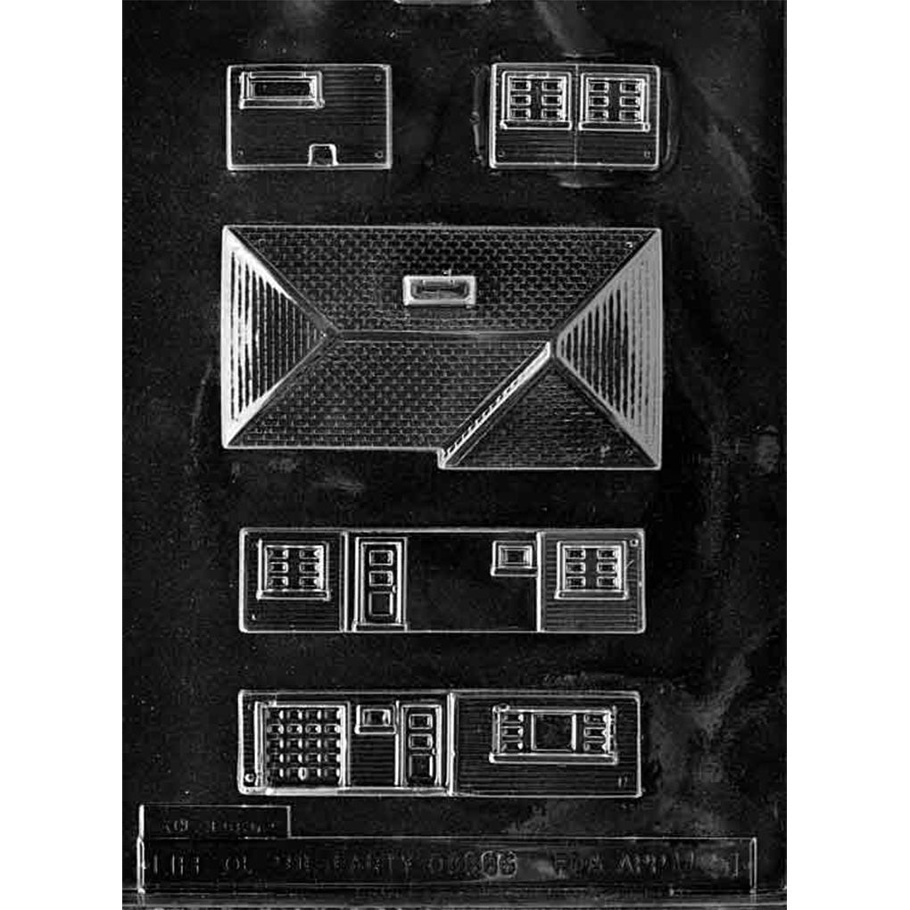 Clear plastic chocolate mold with ranch house building panel cavities, including a large shingled roof piece, long wall panels with door and window outlines, and smaller window sections for assembling a 3D house.
