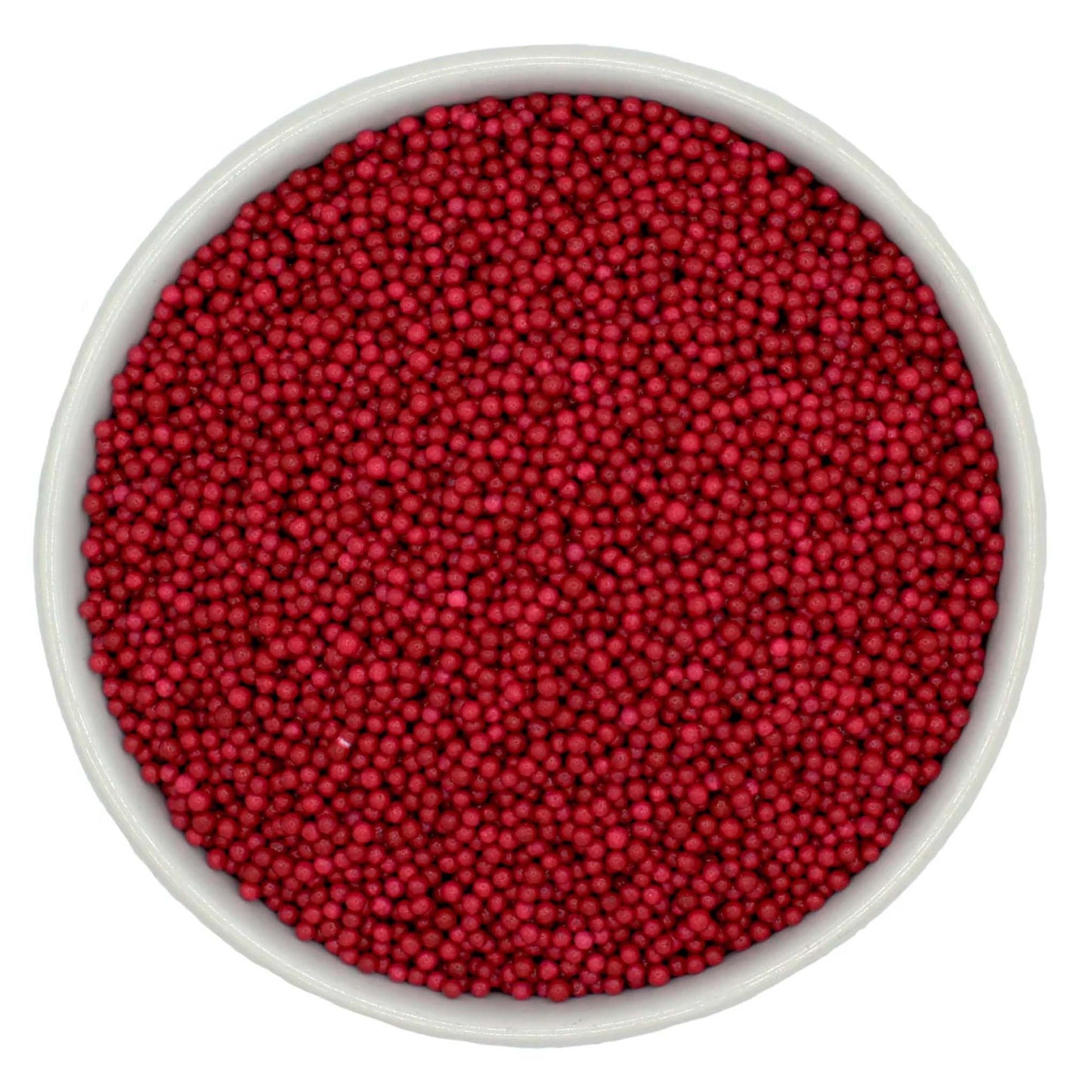Bowl of burgundy nonpareil sprinkles on a white background.