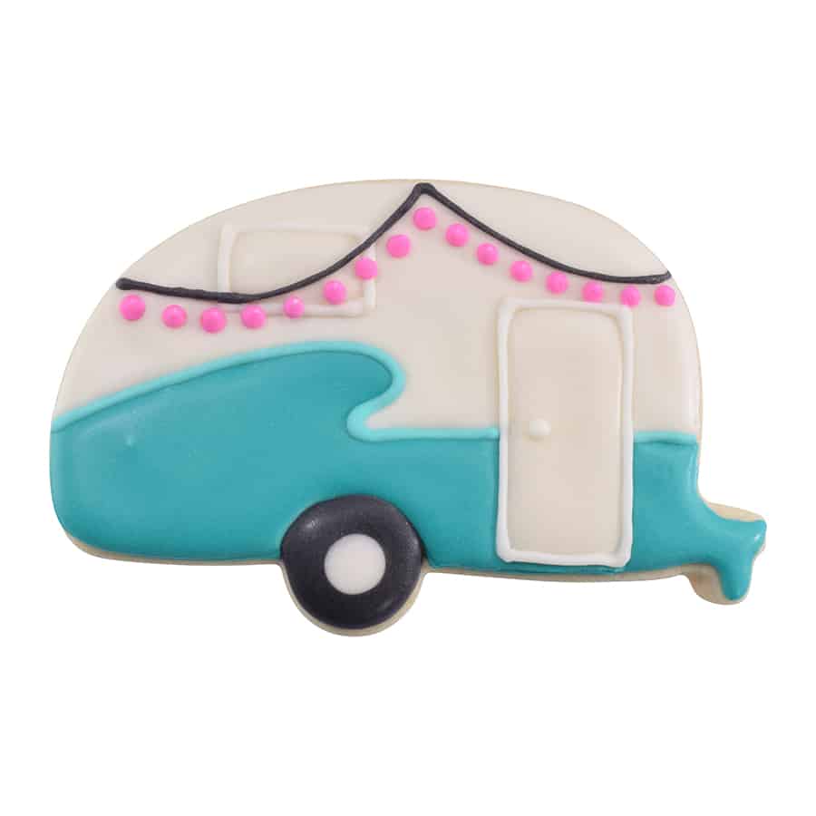 Decorated camper-shaped cookie with blue and white icing, pink string lights, and door details.