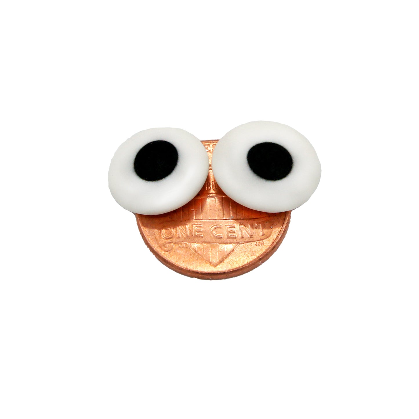 Two 1/2" edible candy eyes on a penny, displaying their size and playful look for cookies, cupcakes, and themed desserts.
