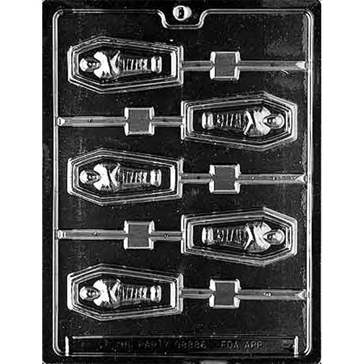 Clear plastic chocolate lollipop mold on a dark background with six coffin-shaped cavities, each showing a mummy inside and a stick channel.