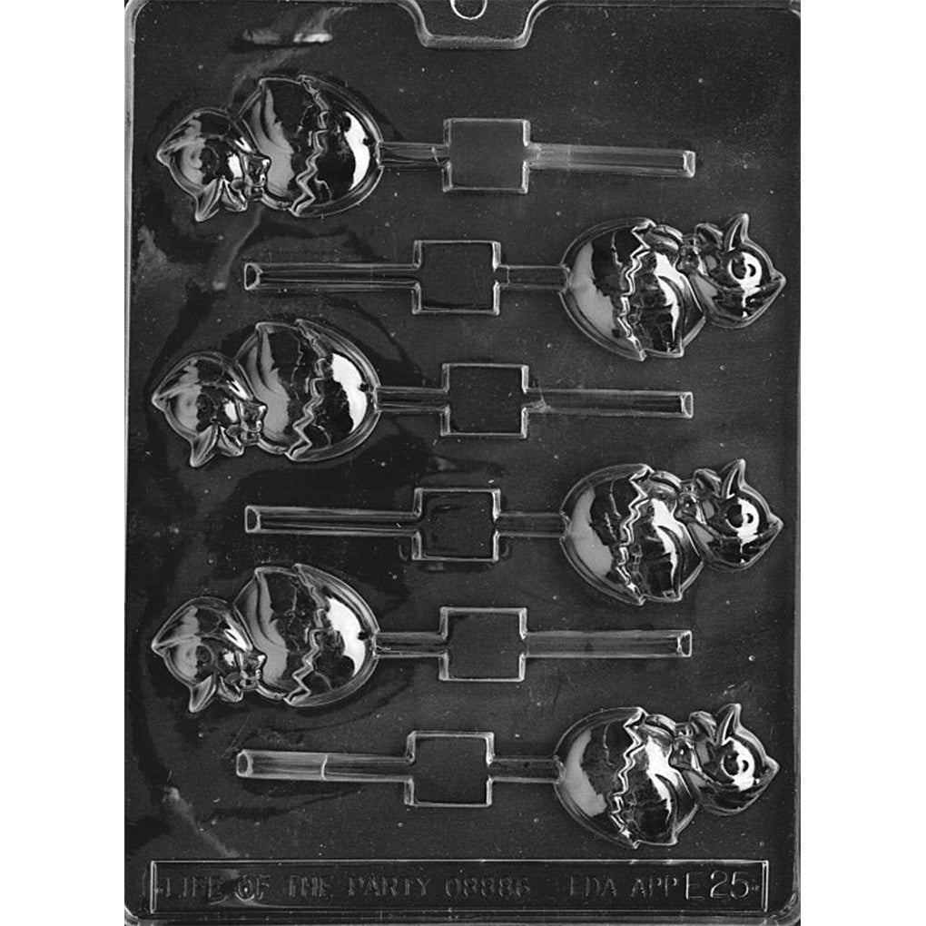 Clear plastic chocolate lollipop mold with chick-in-hatching-egg cavities, showing a raised chick face wearing a bonnet and a cracked eggshell line, with built-in stick slots.