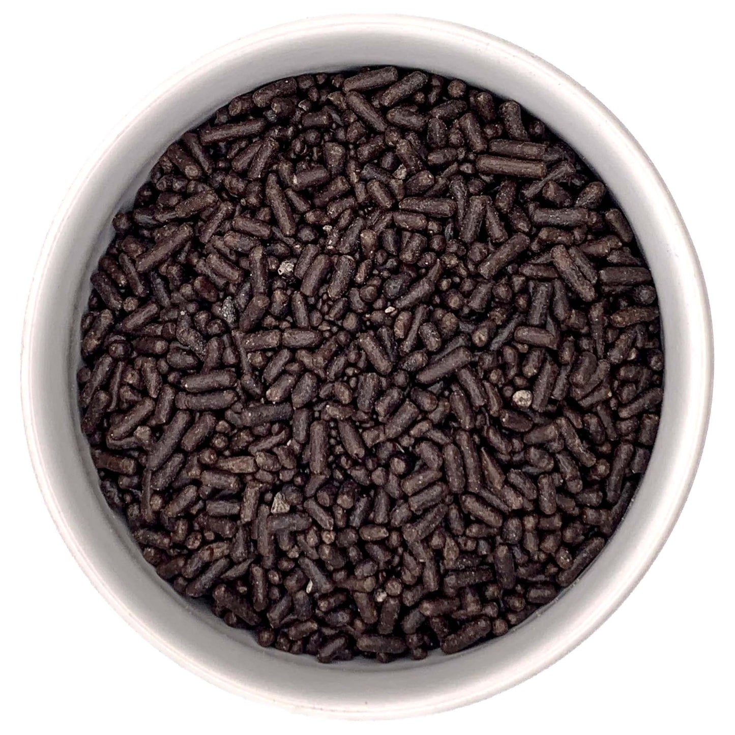 Top-down view of a white bowl filled with dark brown chocolate jimmies sprinkles, showing short rod-shaped pieces and small sprinkle bits.