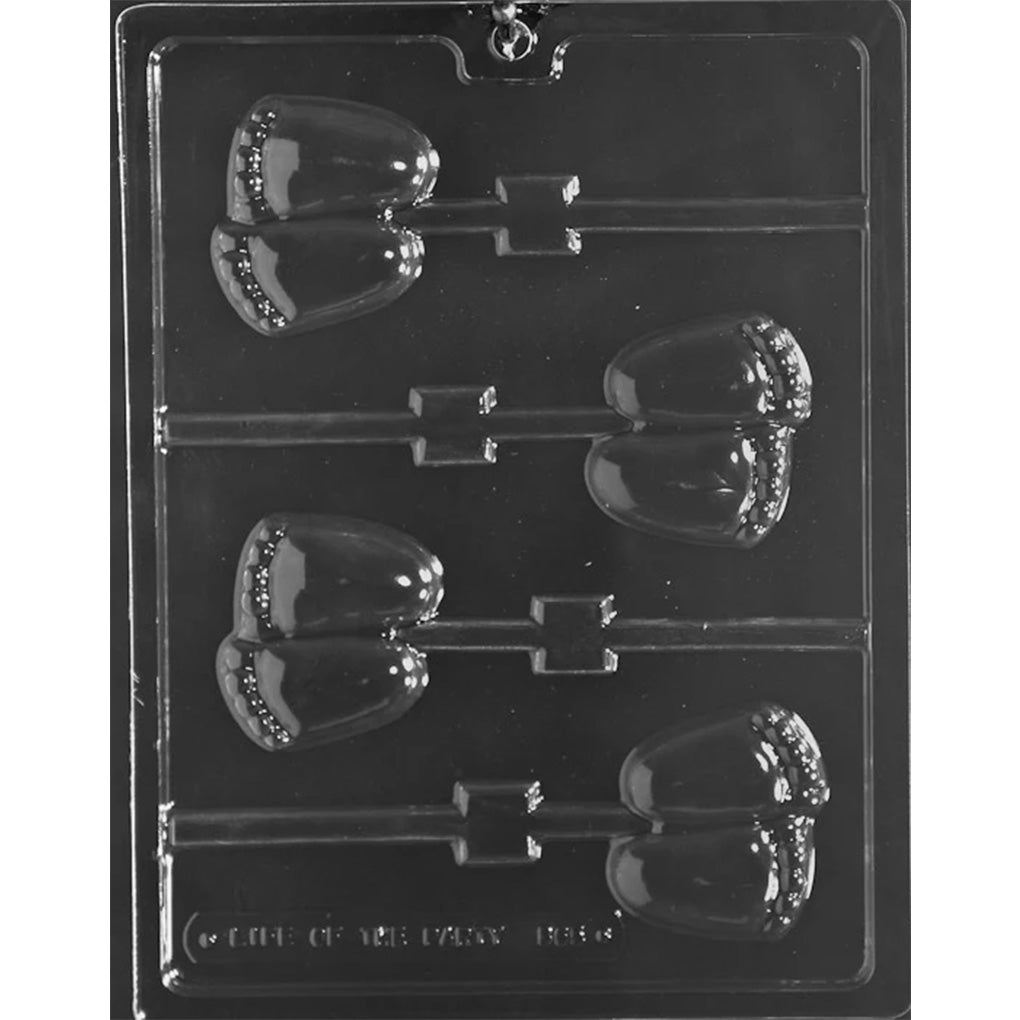 Clear Chubby Baby Feet Chocolate Lollipop Mold photographed against a black background with four paired baby feet cavities featuring rounded soles, tiny toes, and stick channels.