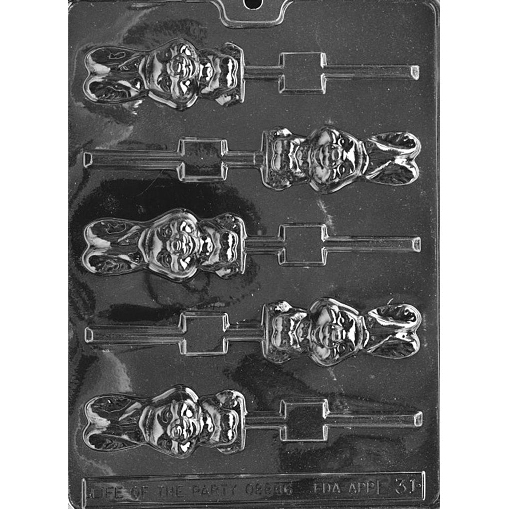 Clear plastic chocolate lollipop mold with chunky bunny-shaped cavities, showing a rounded rabbit face with raised features and long ears, plus built-in stick slots on a dark background.