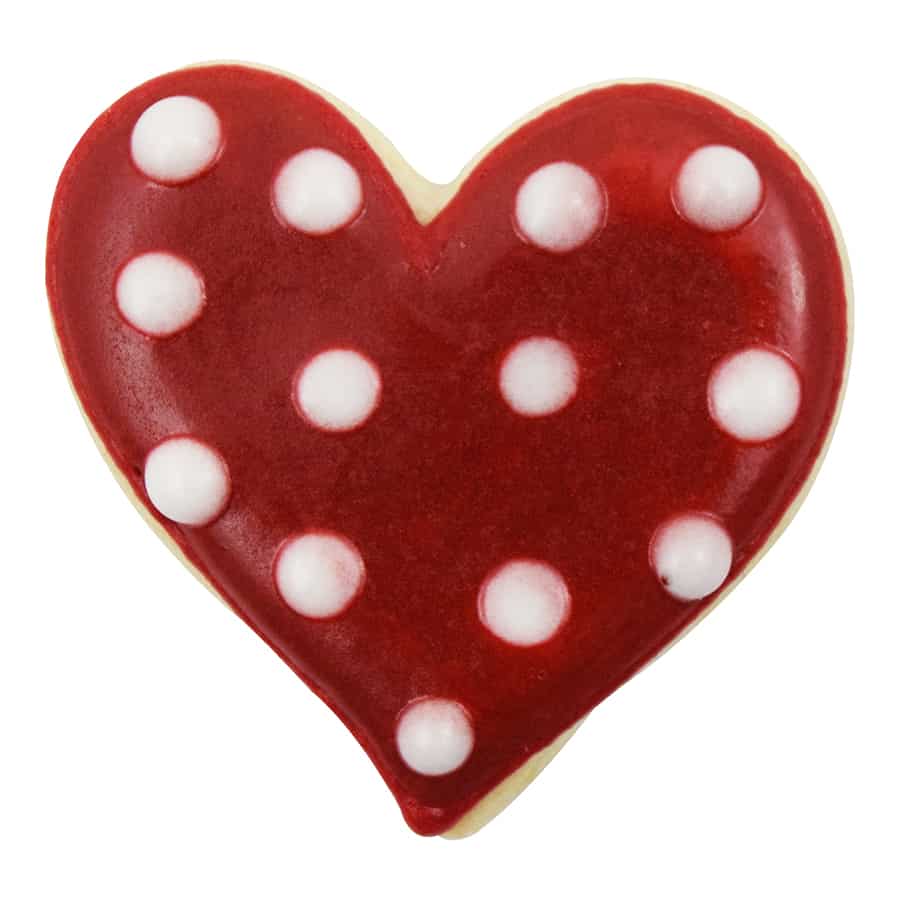 Red heart-shaped cookie with white polka dot decorations.