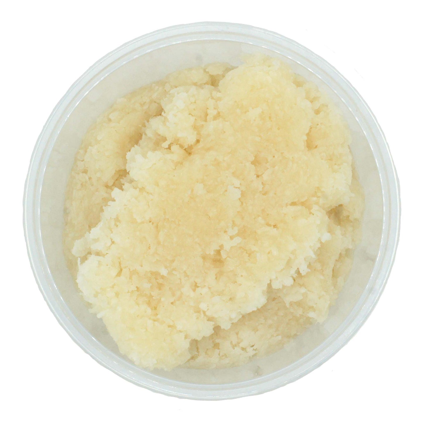 Top view of a tub filled with coconut dough candy center, pale and textured with shredded coconut.