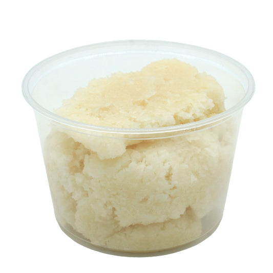 Clear container filled with rich coconut dough candy center, showing real shredded coconut texture.