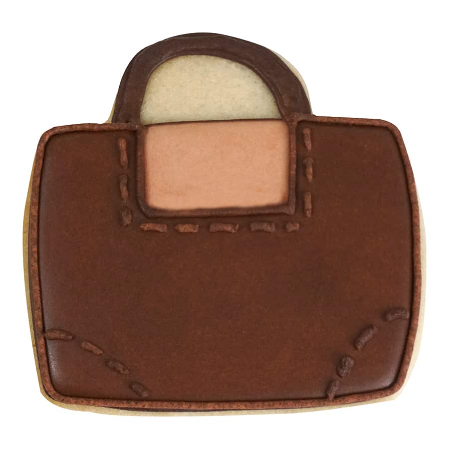 Decorated cookie resembling a brown leather purse with stitched detailing.