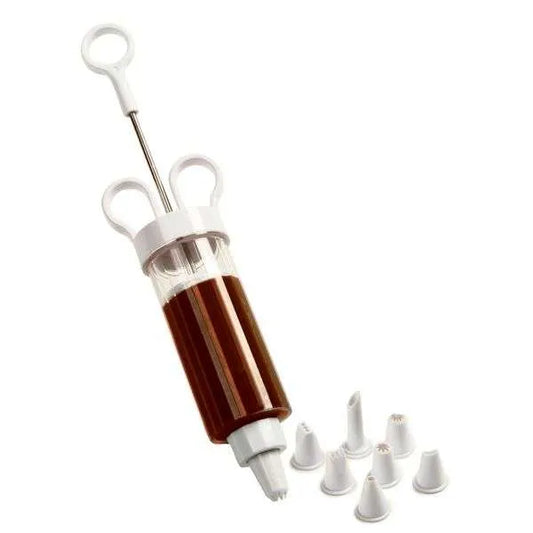 Cupcake injector filled with chocolate next to assorted decorating tips.