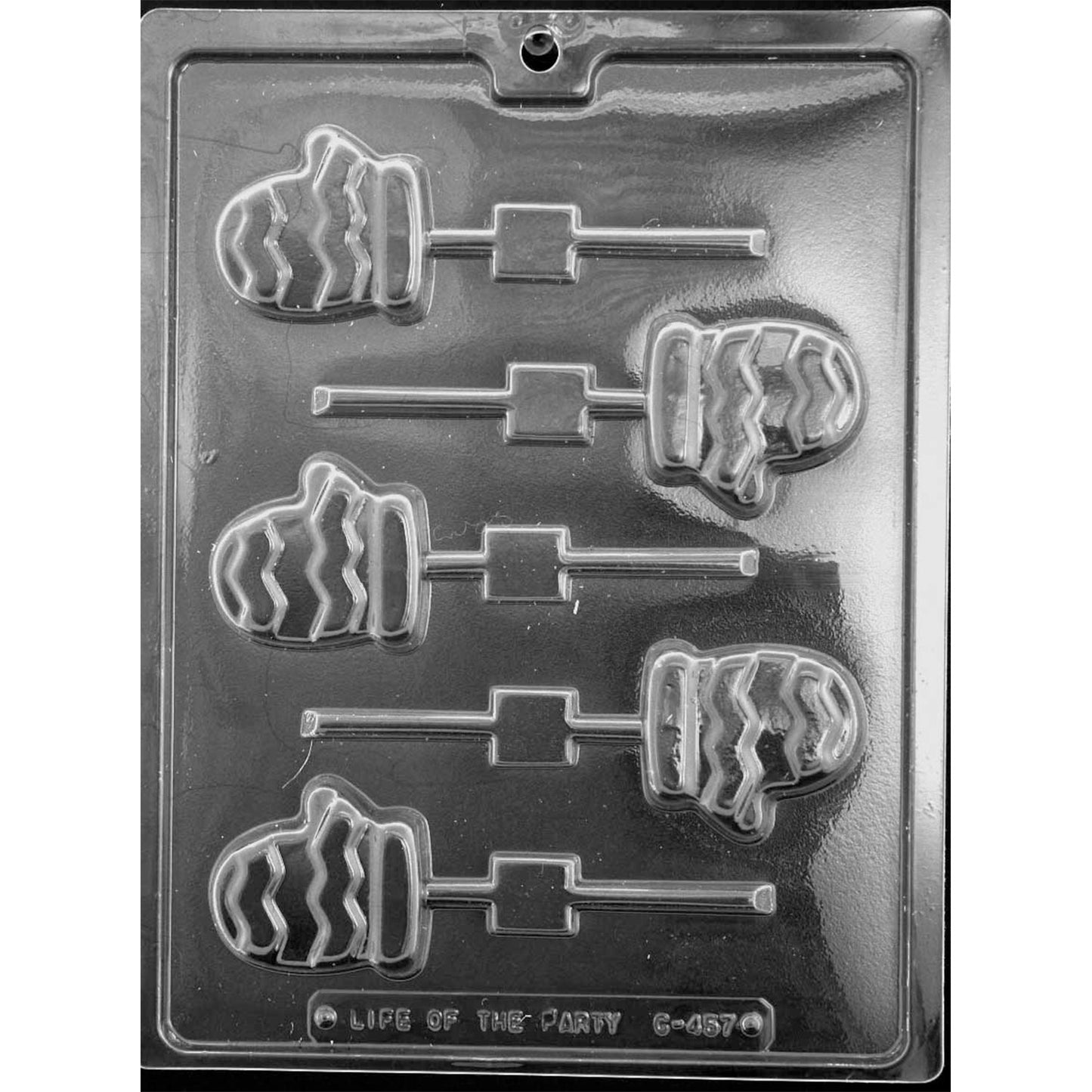 Clear plastic chocolate lollipop mold with six mitten-shaped cavities featuring zigzag knit-style lines and stick channels, shown on a dark background.