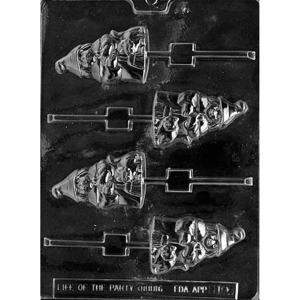 Clear plastic chocolate lollipop mold on a dark background with four witch-shaped cavities, each showing a pointed-hat witch holding a broom with a small cat beside her.