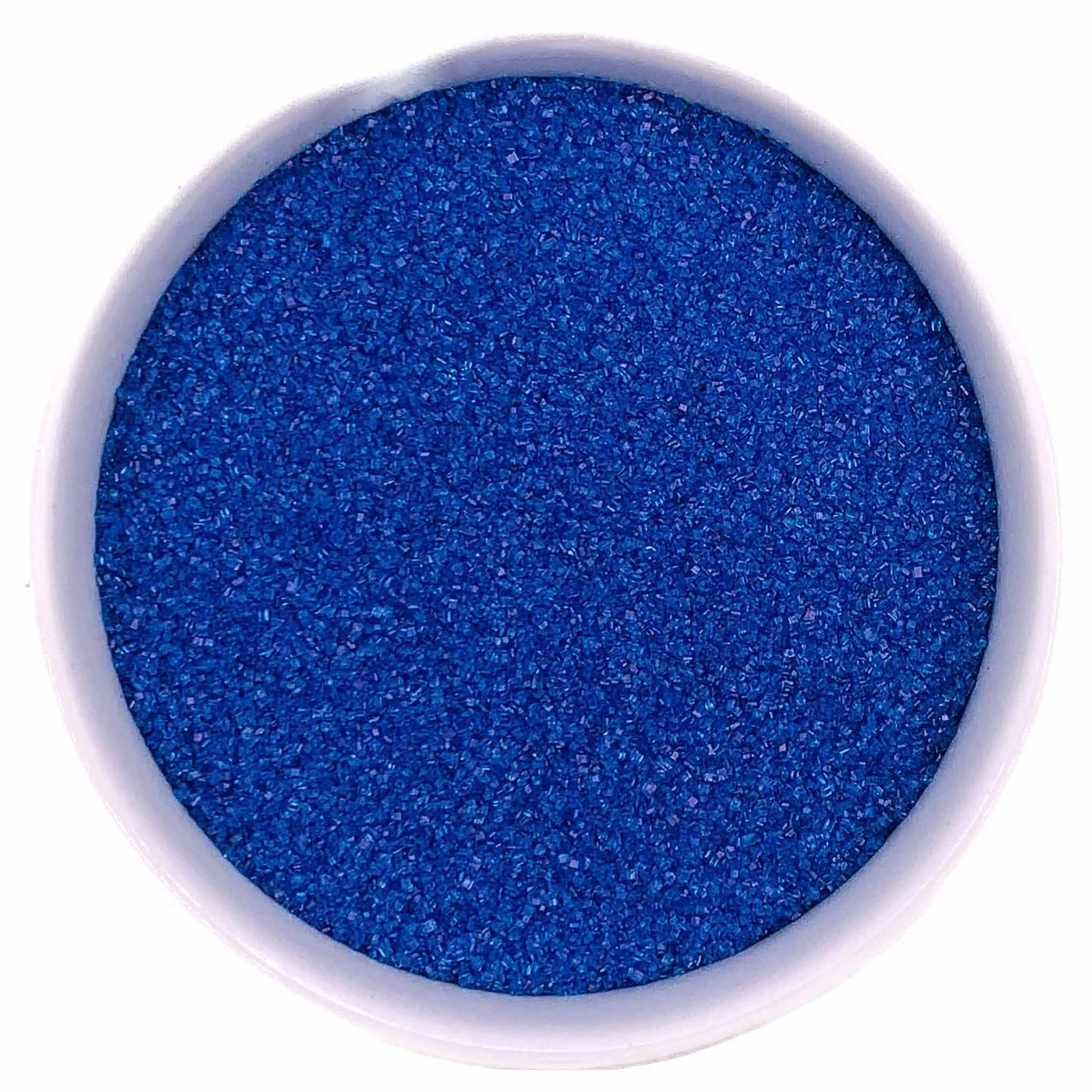 Bowl of dark blue fine sanding sugar crystals in a white container on a white background.