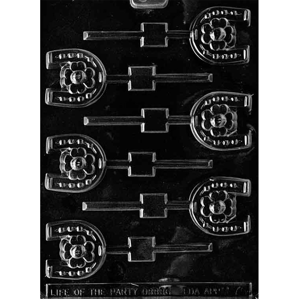 Clear Horseshoe Chocolate Lollipop Mold photographed against a black background with eight horseshoe-shaped cavities featuring flower centers, raised nail details, and stick channels.