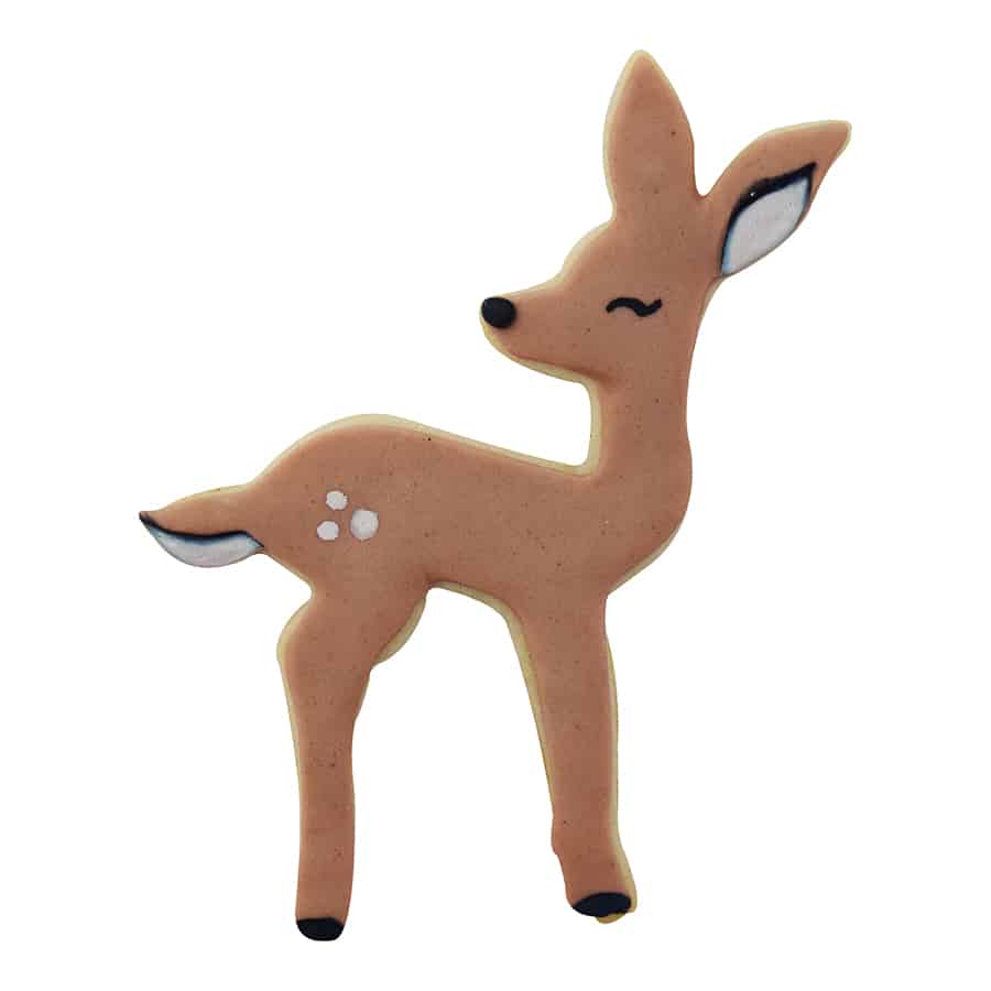 Decorated deer fawn cookie with brown icing, black hooves, white spots, and a smiling face, made using the cookie cutter.