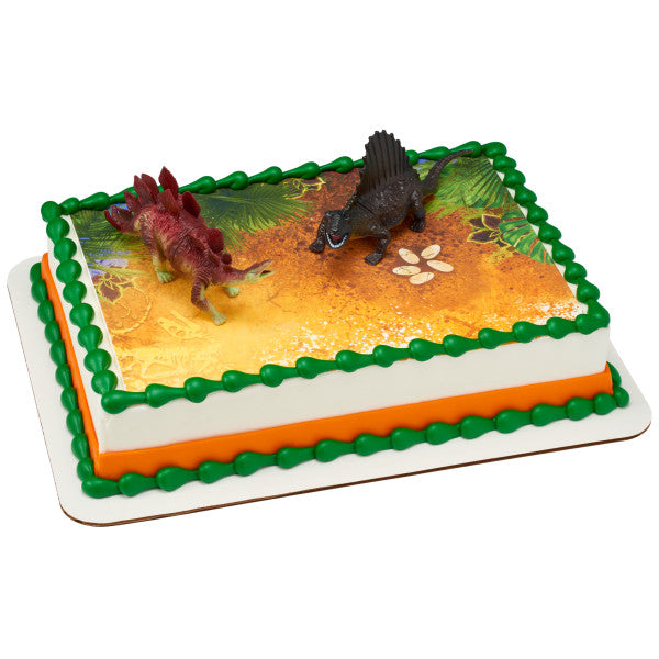 Sheet cake with green and orange border, printed prehistoric scene, and two dinosaur toppers.