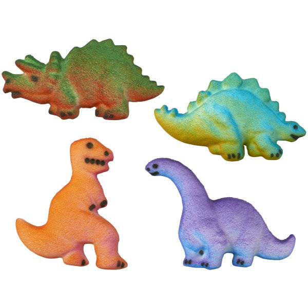 Close-up of four assorted dinosaur pressed sugar decorations including a triceratops, stegosaurus, T-Rex, and brontosaurus in bright edible colors