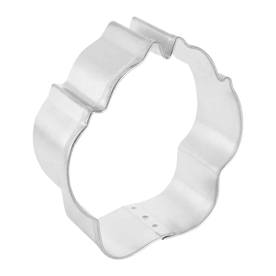 Side view of a dog paw-shaped cookie cutter made of tinplated steel, showing its sturdy construction and curved details.