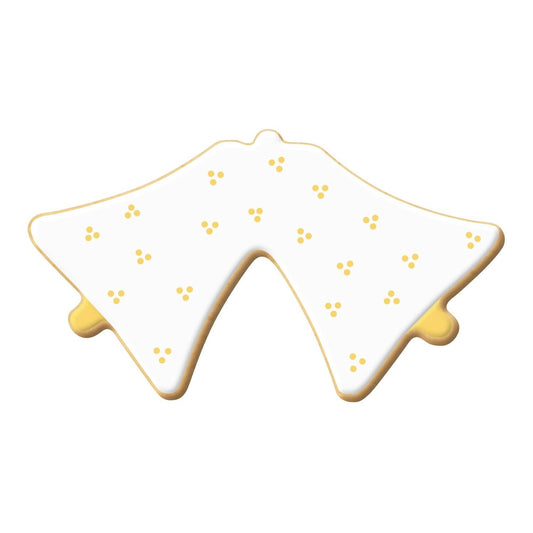 Decorated cookie shaped like double bells, covered in white icing with gold dot details.