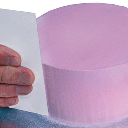 PME Extra Tall Scraper being used on a tall purple cake on a turntable for smooth sides