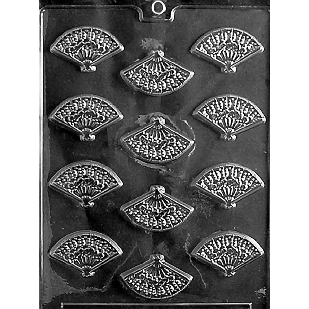 Clear Fan Mints Chocolate Mold photographed against a black background with 12 fan-shaped cavities featuring ornate floral and lace-style detailing.