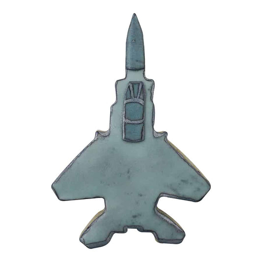 A decorated cookie shaped like a fighter jet, featuring a blue-gray color with cockpit and panel details.