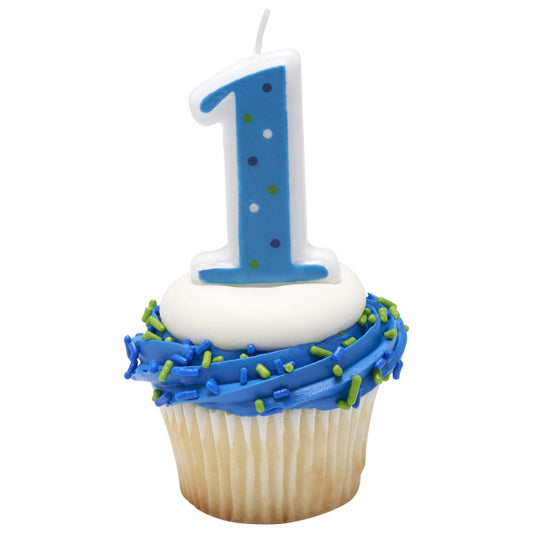 Blue number 1 candle with polka dots placed on a blue-and-white frosted cupcake, perfect for a 1st birthday celebration.