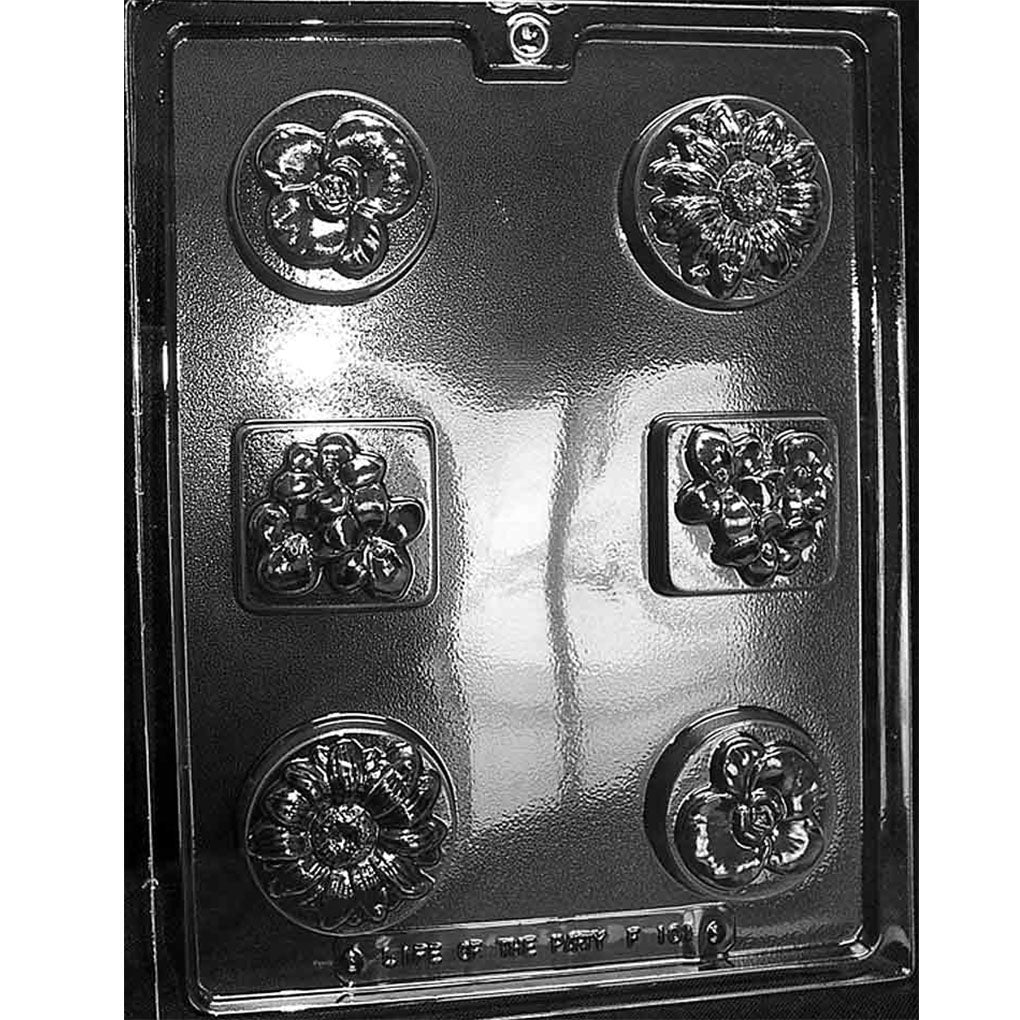 Clear plastic chocolate mold with six floral cavities in assorted shapes, including round pansy and sunflower designs and square flower cluster designs.