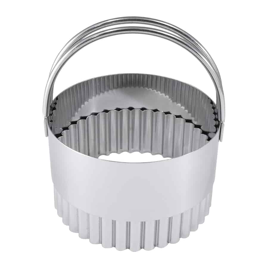 Stainless steel fluted biscuit cutter with an arched handle for easy cutting.