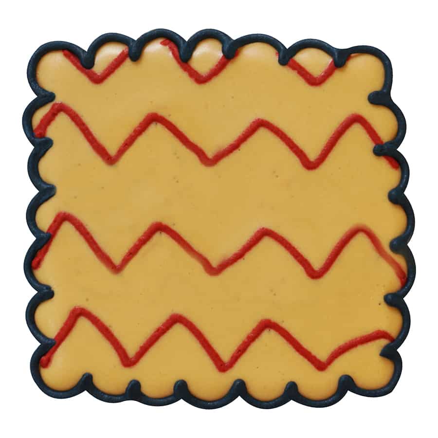 Yellow cookie with red and black zigzag piping, made using the Square Fluted Cookie Cutter.