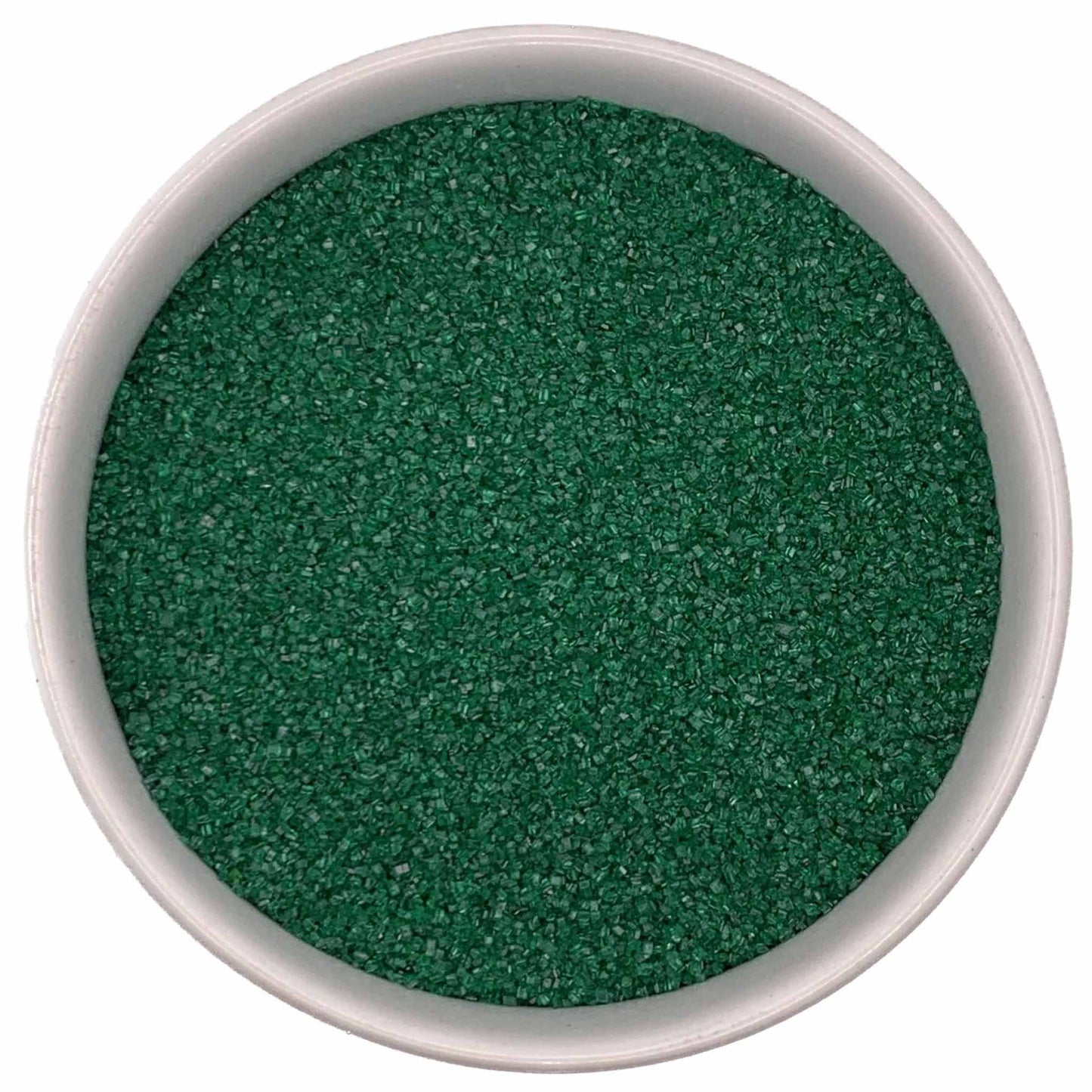 Top-down view of a white bowl filled with deep green fine sanding sugar crystals, tightly packed with a subtle sparkle.