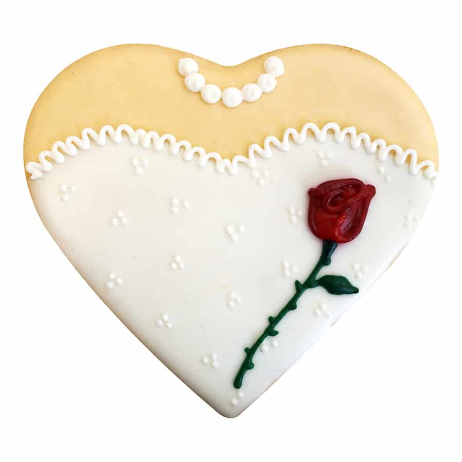 Heart cookie decorated like a wedding dress with rose and pearl detail