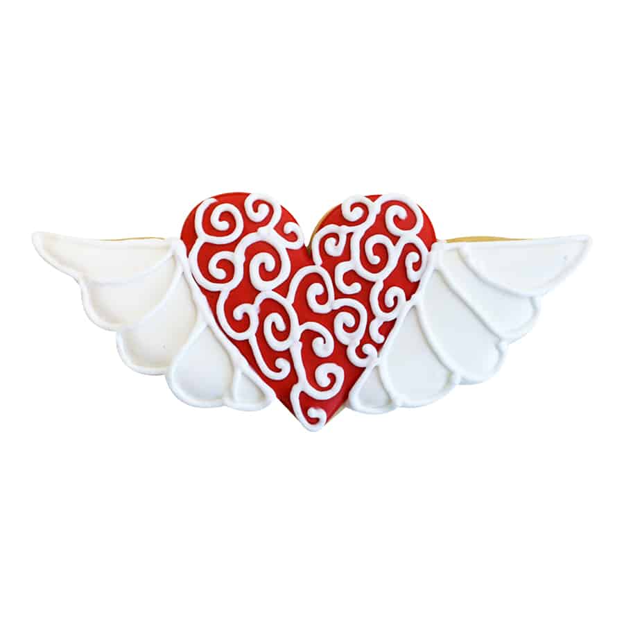 Decorated heart with wings cookie featuring a red and white swirled heart with white wings.