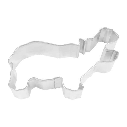 Overhead view of a hippo-shaped metal cookie cutter with a wide-open mouth.