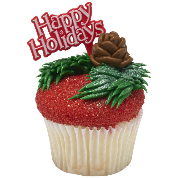 Holiday-themed cupcake with red sanding sugar, piped green leaves, and a pinecone, topped with a “Happy Holidays” pick.