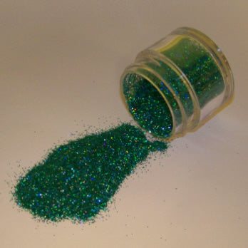 Deep emerald green Galaxy Glitter Dust spilled from a container, glistening with a mix of blue and gold reflective highlights.