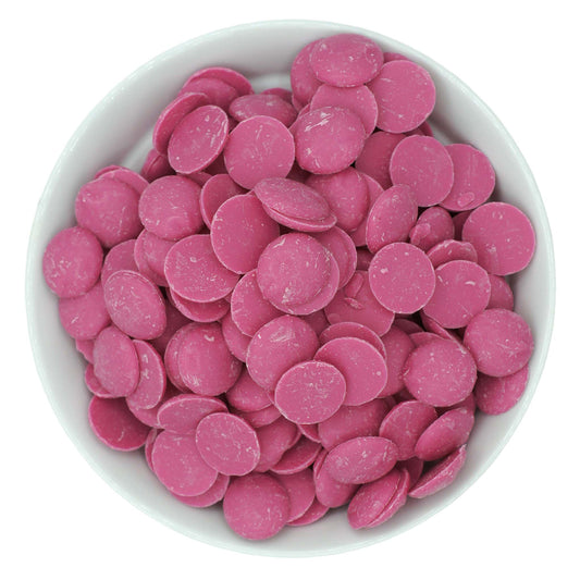 Pink candy melting wafers in a white bowl, shown from overhead on a white background.