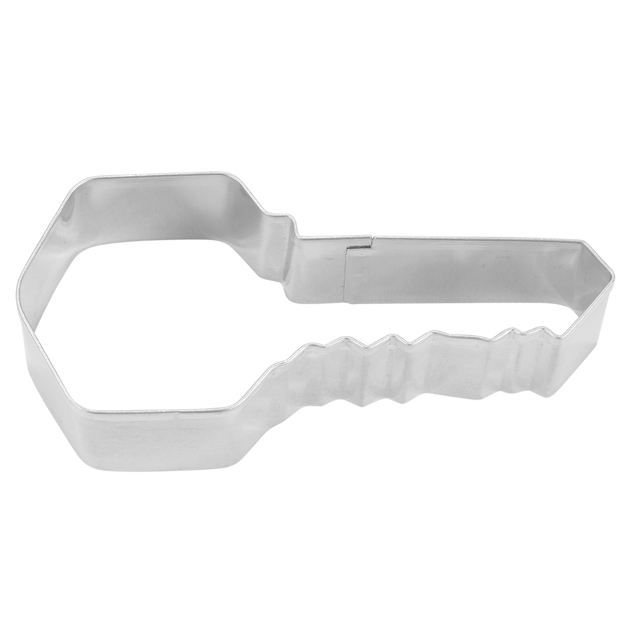 House key-shaped cookie cutter with a detailed notched edge, photographed from a top-down angle.