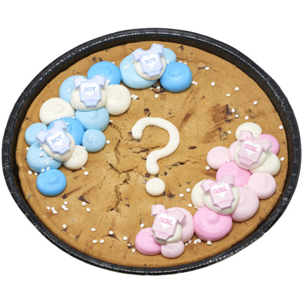 Giant gender reveal cookie cake decorated with pink and blue icing and onesie cupcake rings
