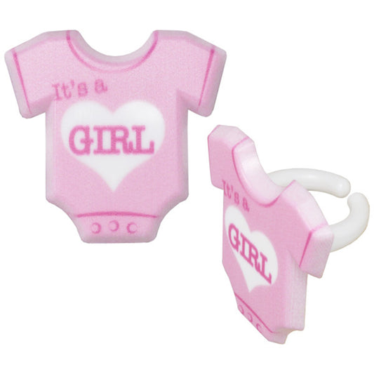 Close-up of pink "It's a Girl" cupcake rings shaped like a baby onesie with adjustable backing