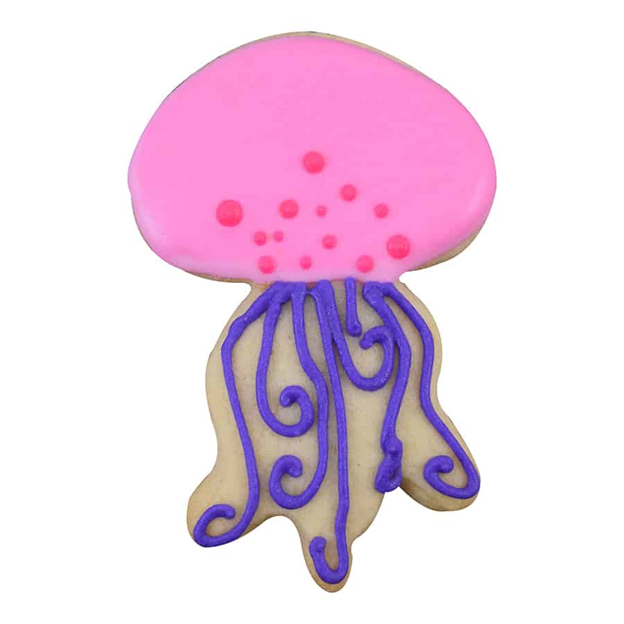 A bright pink jellyfish cookie with purple piped tentacles and small decorative dots.