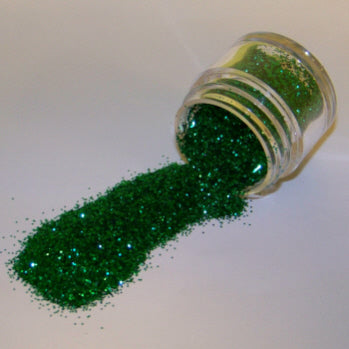 Classic green Galaxy Glitter Dust spilled from a jar, radiating bright, festive sparkle with a rich emerald tone.