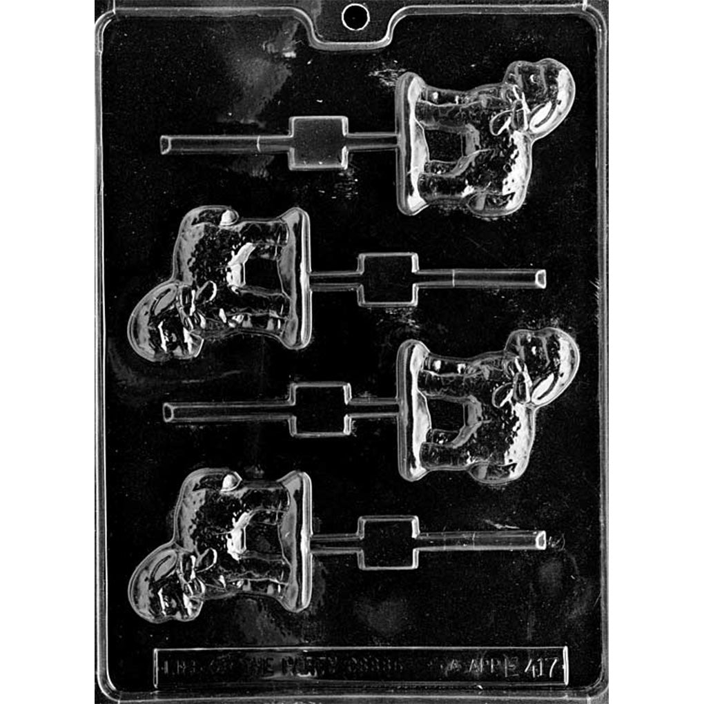 Clear plastic chocolate lollipop mold with five cavities shaped like a full lamb with floppy ears, a bow at the neck, and textured wool detail, each connected to a stick channel on a dark background.