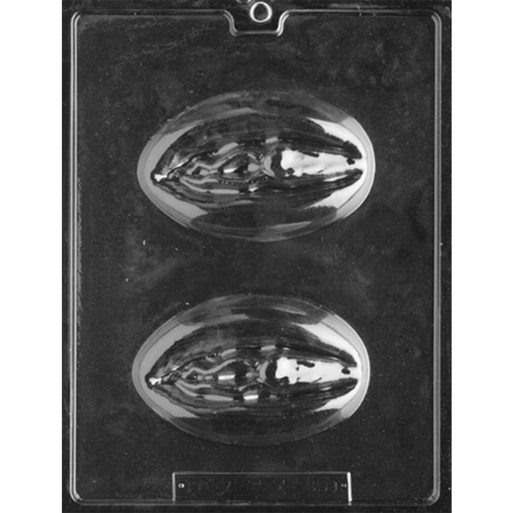 Clear plastic adult chocolate mold photographed against a black background with two large oval cavities featuring sculpted female anatomy-inspired details.
