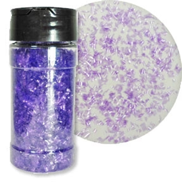 Clear shaker bottle filled with lavender-purple edible glitter flakes beside a white round sample covered with scattered translucent lavender flakes.