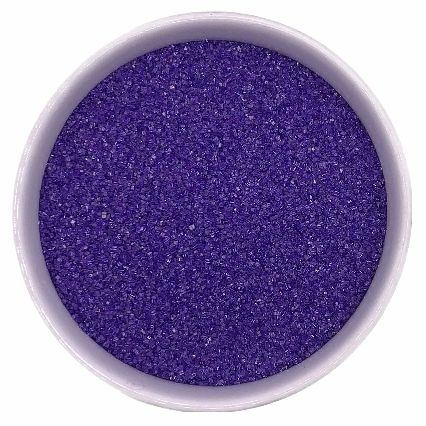 Top-down view of a white bowl filled with lavender fine sanding sugar, showing tiny sparkling crystals in a soft purple-lavender shade.