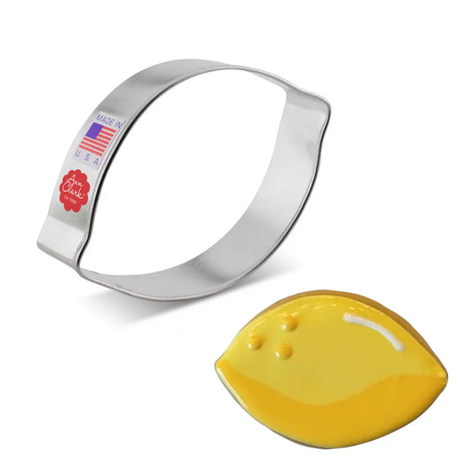 Lemon cookie cutter next to a decorated lemon-shaped sugar cookie with yellow icing.