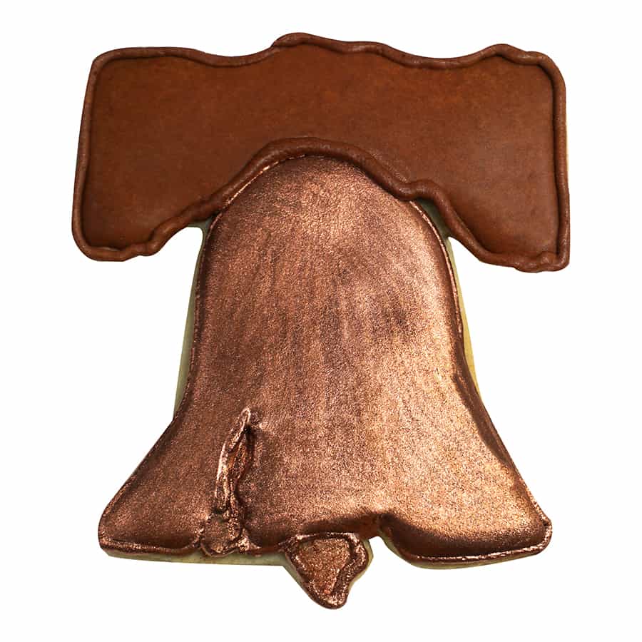 Decorated Liberty Bell cookie with metallic bronze icing and realistic crack detail.