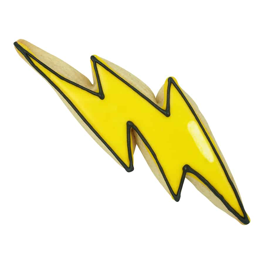 Decorated lightning bolt cookie with bright yellow icing and black outline, perfect for comic book or superhero-themed desserts.